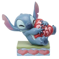 Figurine stitch câlinant un coeur - disney traditions